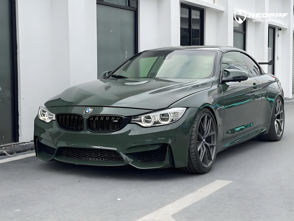 A sports car with British Green Metallic paint protection film colored wrap is parking in the garage
