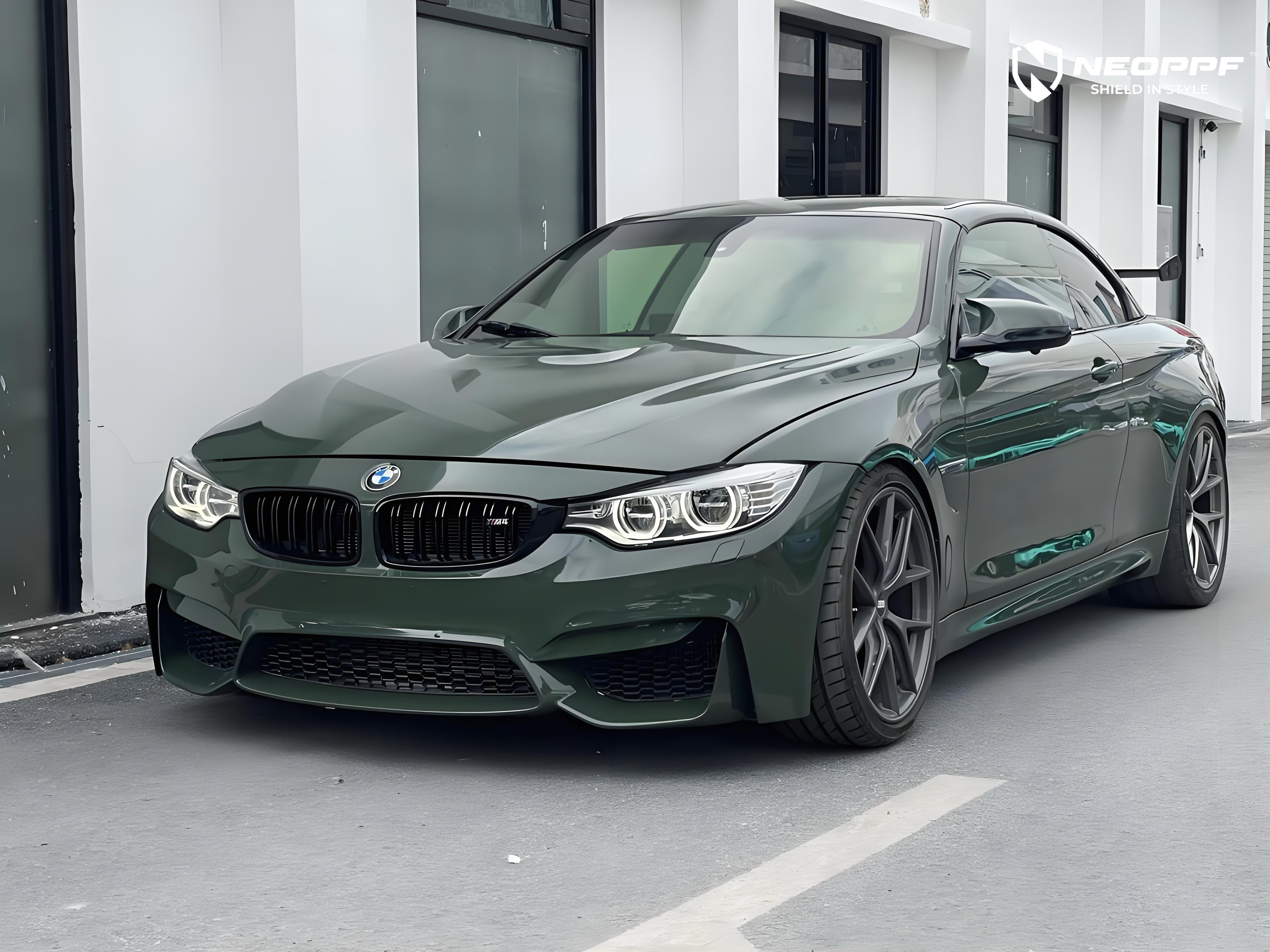 A sports car with British Green Metallic paint protection film colored wrap is parking in the garage
