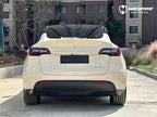 A sports car with Pepper White paint protection film colored wrap is parking in the garage