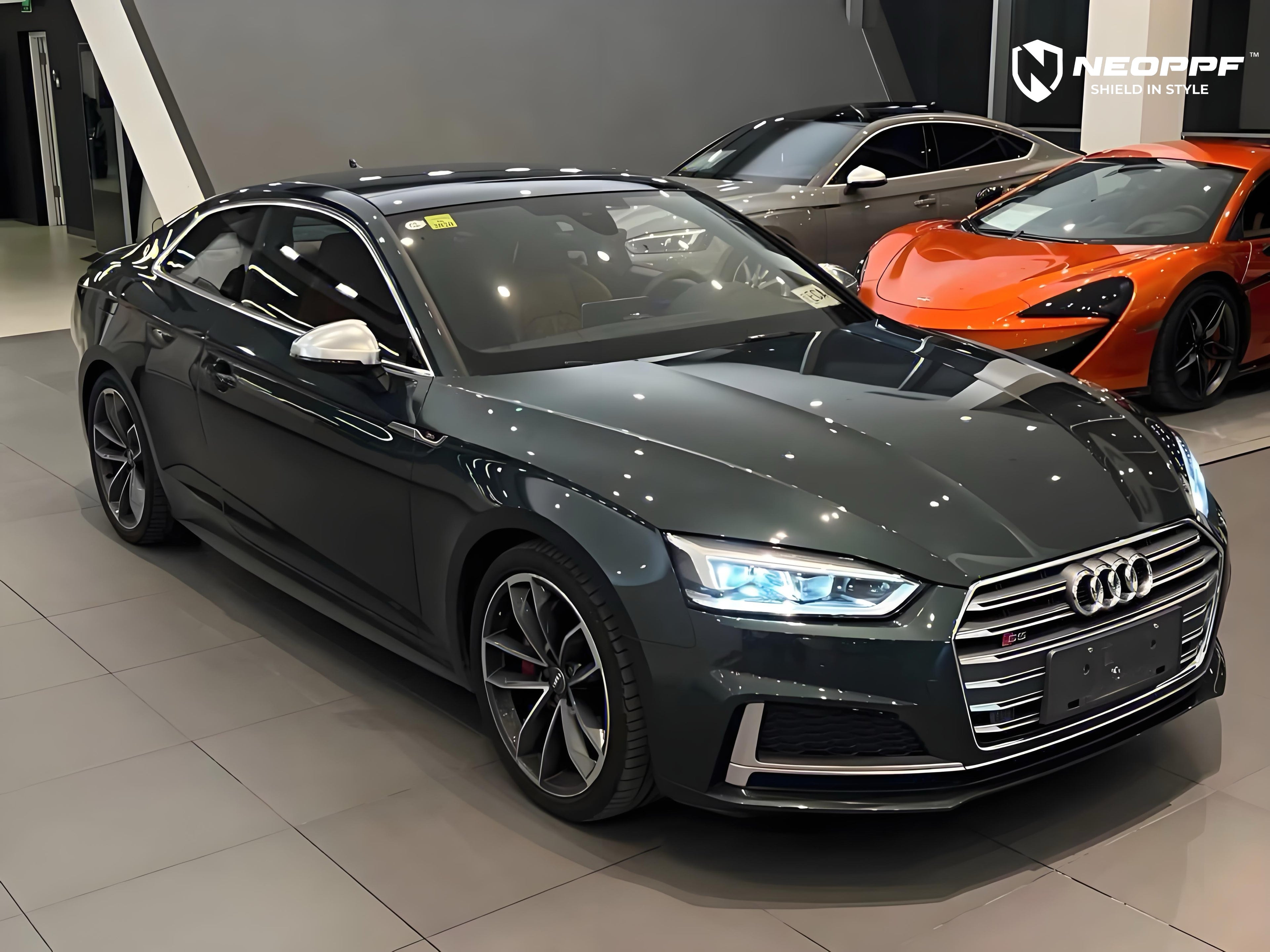 A sports car with Gotland Green paint protection film colored wrap is parking in the garage