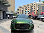 A sports car with Sonoma Green paint protection film colored wrap is parking in the garage