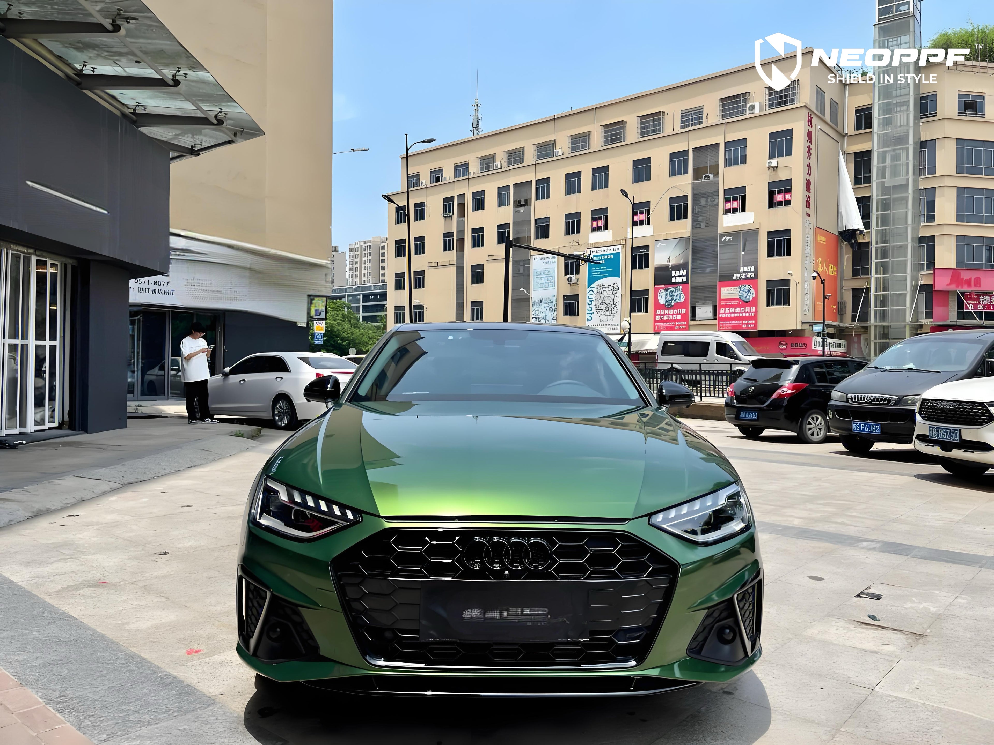 A sports car with Sonoma Green paint protection film colored wrap is parking in the garage
