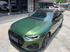 A sports car with Sonoma Green paint protection film colored wrap is parking in the garage