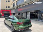 A sports car with Sonoma Green paint protection film colored wrap is parking in the garage