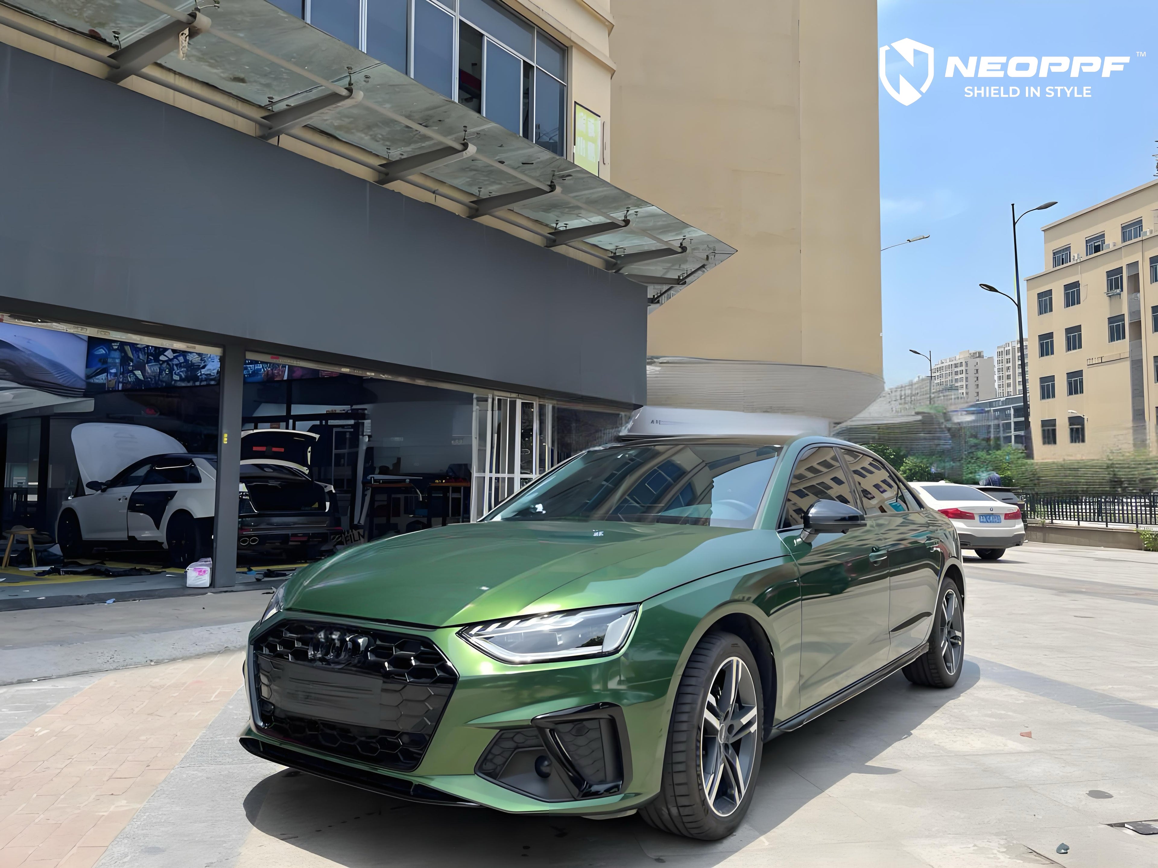 A sports car with Sonoma Green paint protection film colored wrap is parking in the garage