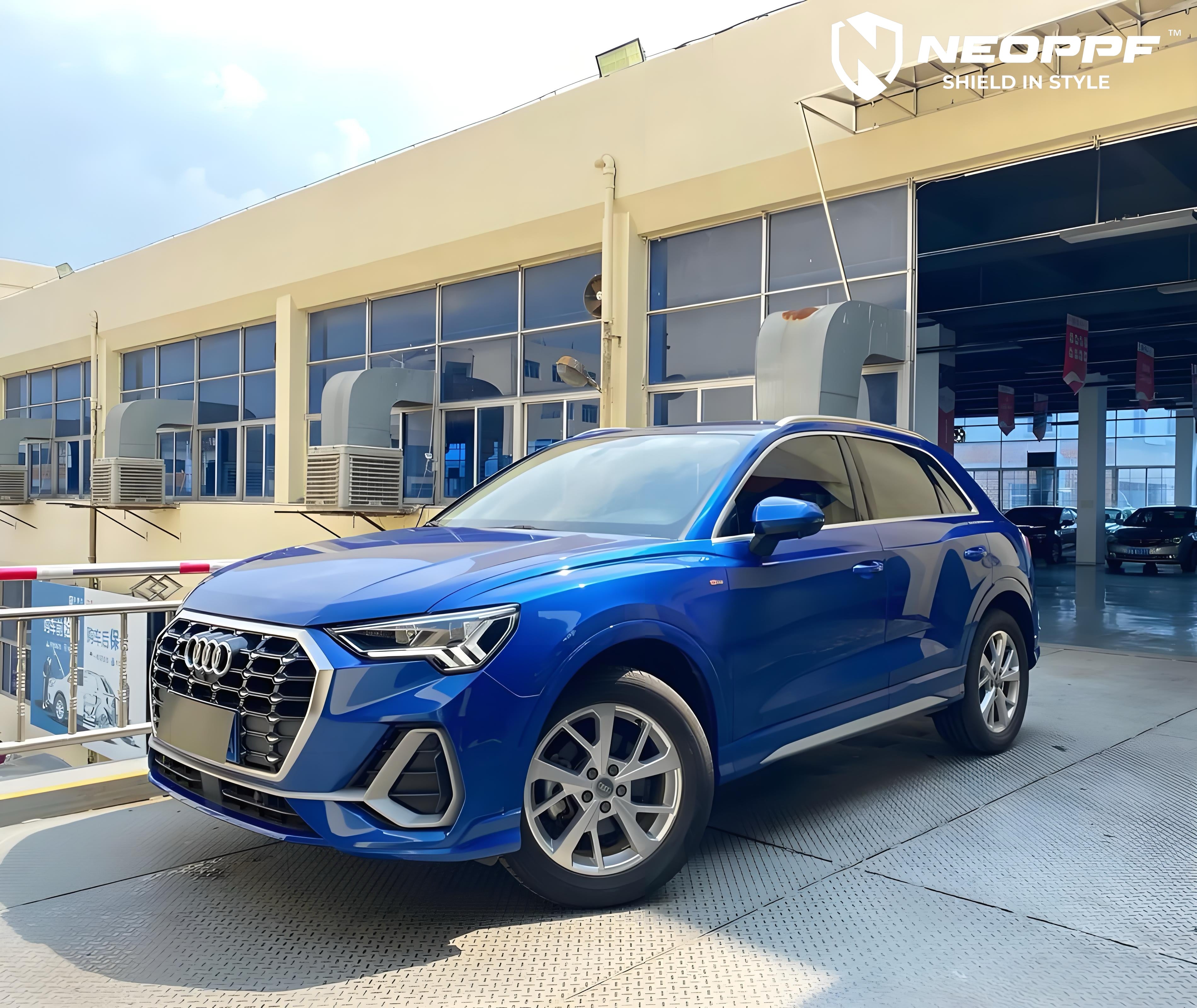 A sports car with Sepang Blue paint protection film colored wrap is parking in the garage