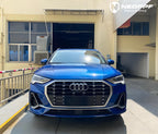 A sports car with Sepang Blue paint protection film colored wrap is parking in the garage