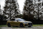 A sports car with Combat Green paint protection film colored wrap is parking in the garage