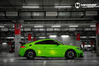 A sports car with Viper Green paint protection film colored wrap is parking in the garage