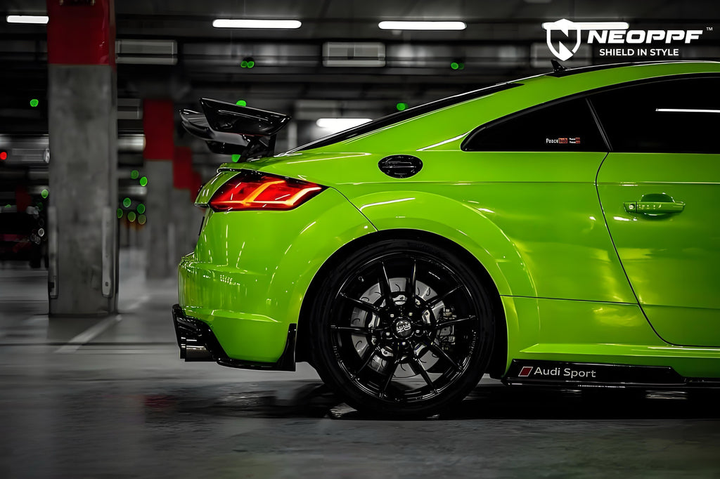 A sports car with Viper Green paint protection film colored wrap is parking in the garage