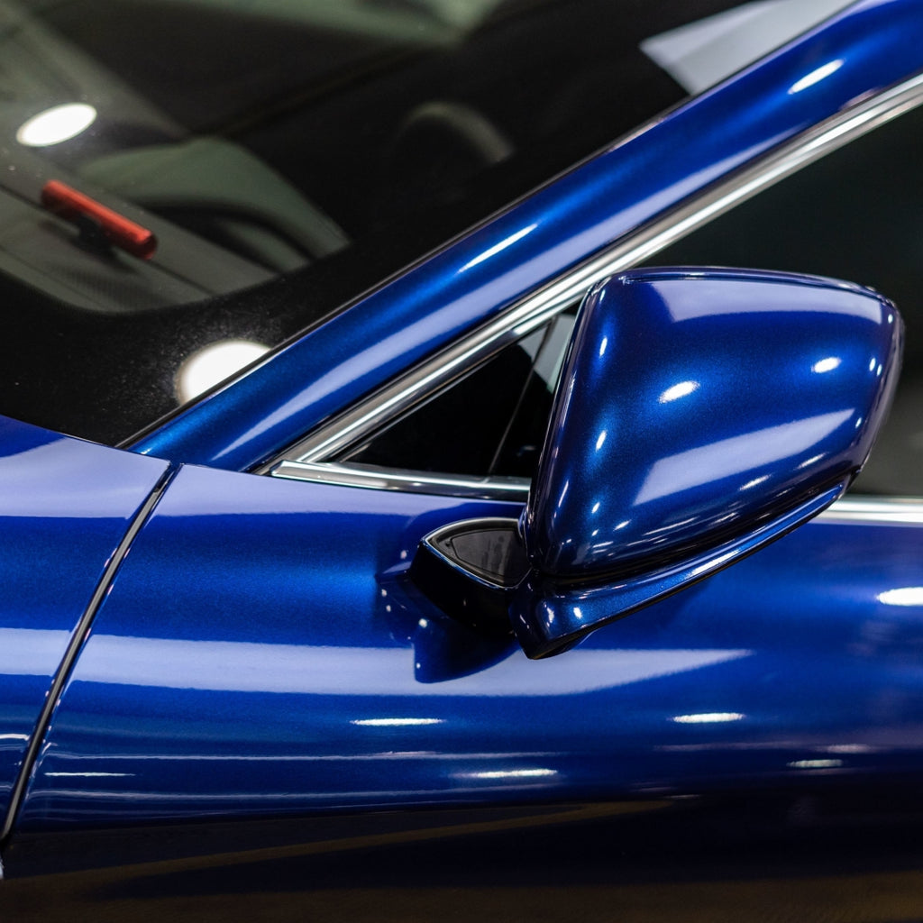 A sports car with Gentian Blue paint protection film colored wrap is parking in the garage