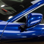 A sports car with Gentian Blue paint protection film colored wrap is parking in the garage