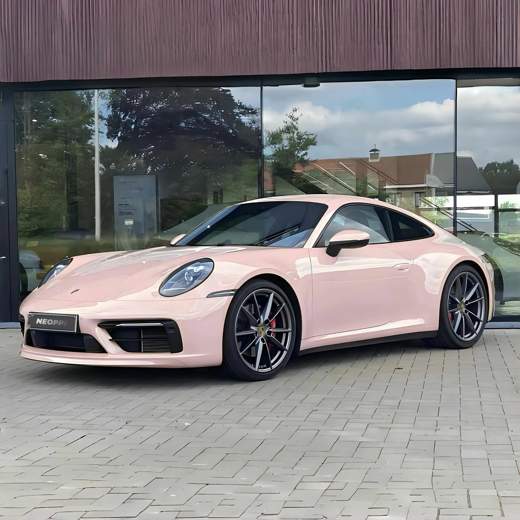 A sports car with Shell Pink paint protection film colored wrap is parking in the garage