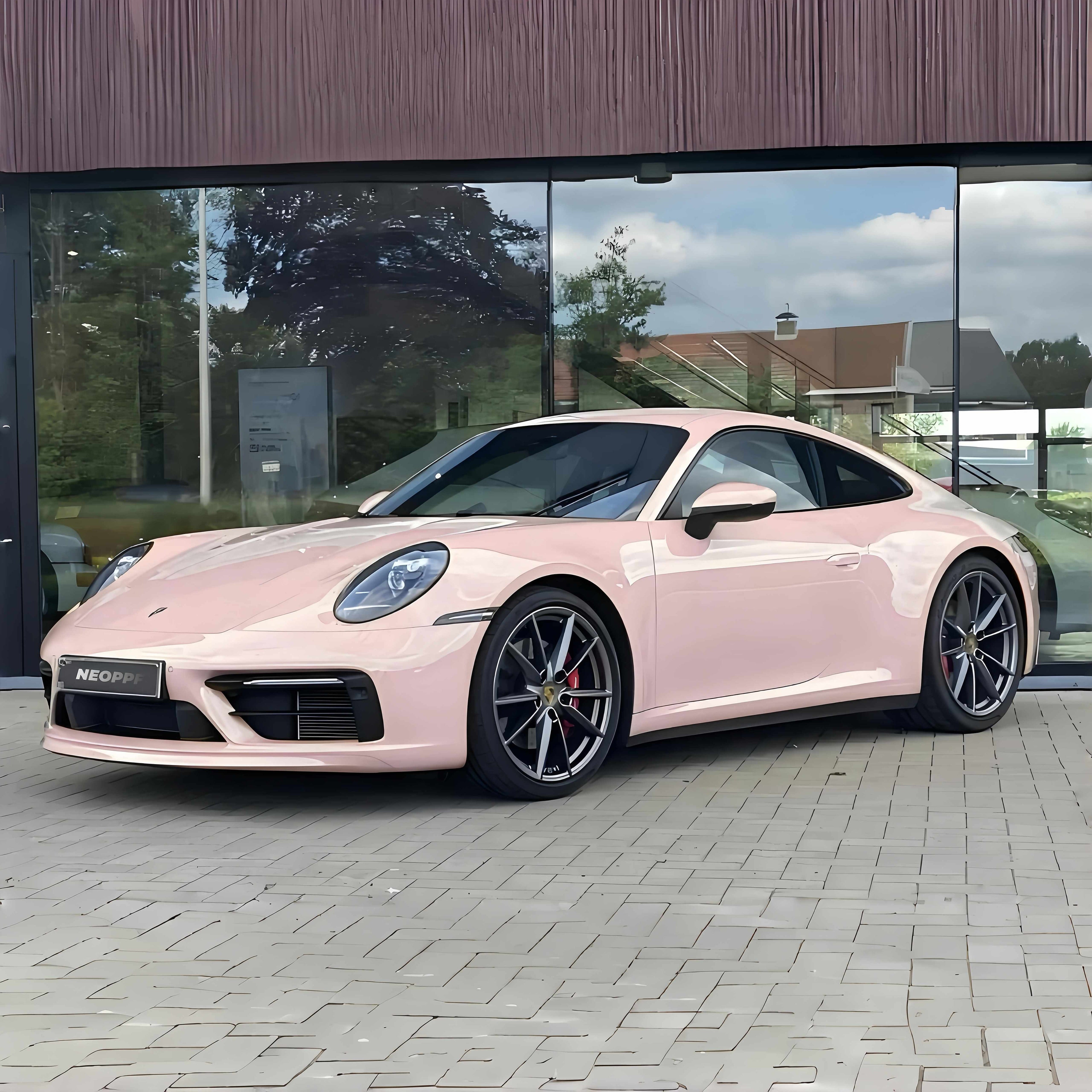 A sports car with Shell Pink paint protection film colored wrap is parking in the garage
