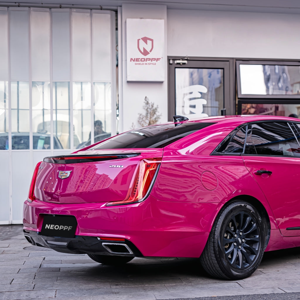 A sports car with Starlight Ruby Red paint protection film colored wrap is parking in the garage