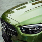 A sports car with Mamba Green paint protection film colored wrap is parking in the garage
