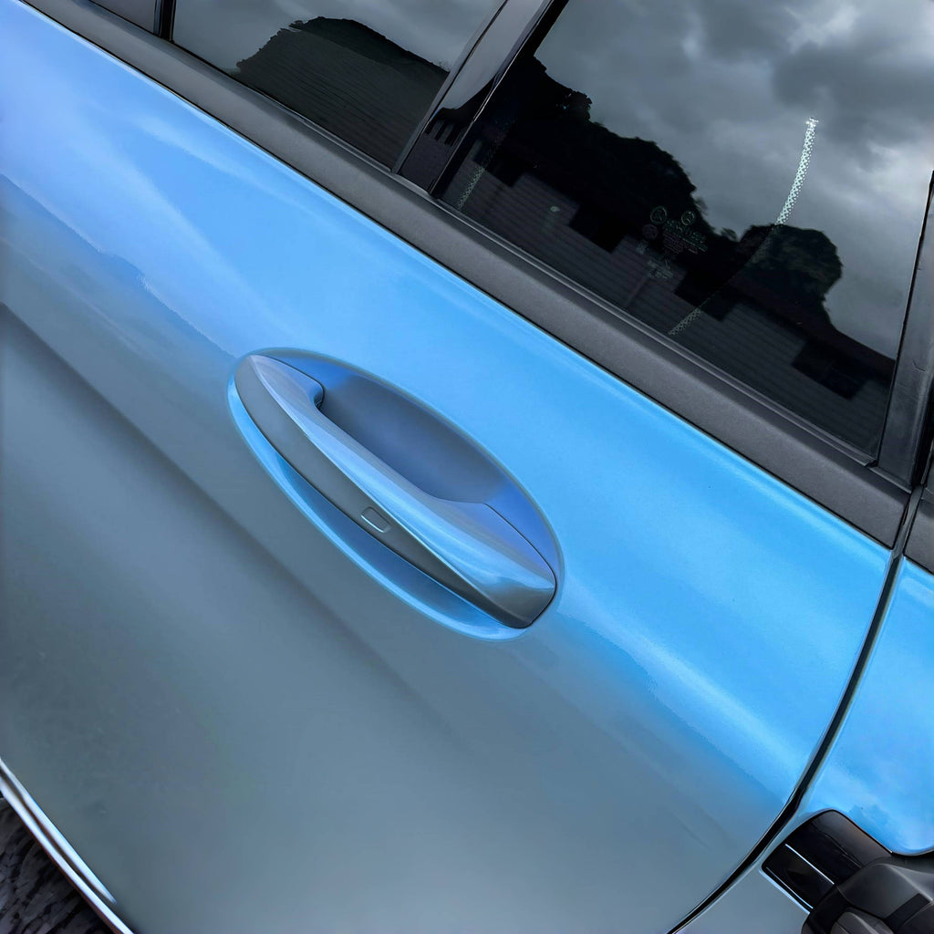 A sports car with Rock Gray paint protection film colored wrap is parking in the garage