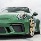 A sports car with Onium Green paint protection film colored wrap is parking in the garage