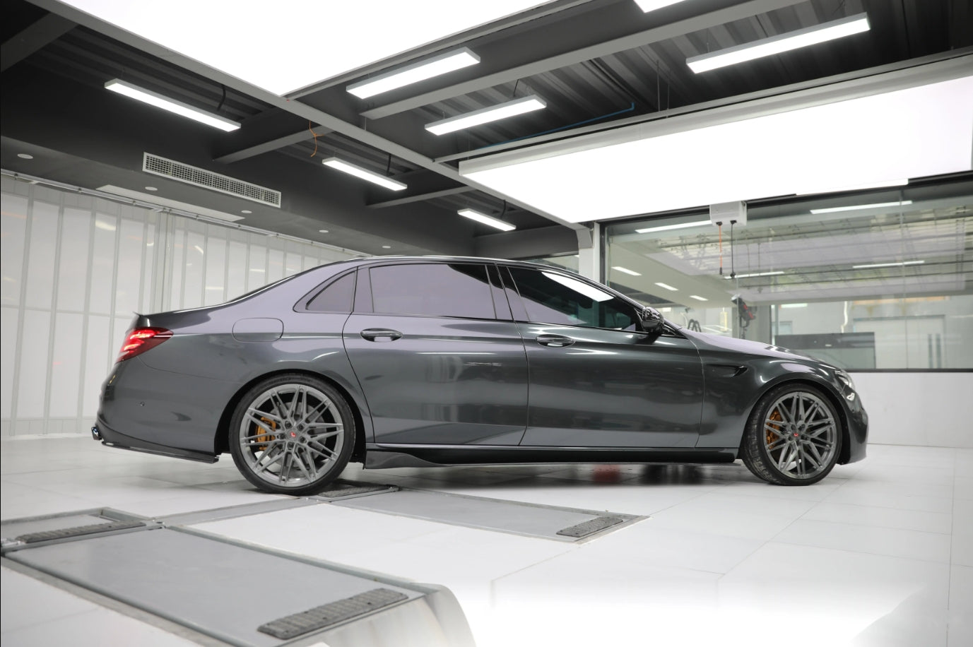 A sports car with Coal Gray paint protection film colored wrap is parking in the garage