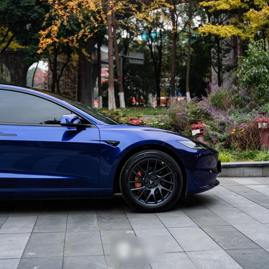 A sports car with Cobalt Blue Metallic paint protection film colored wrap is parking in the garage
