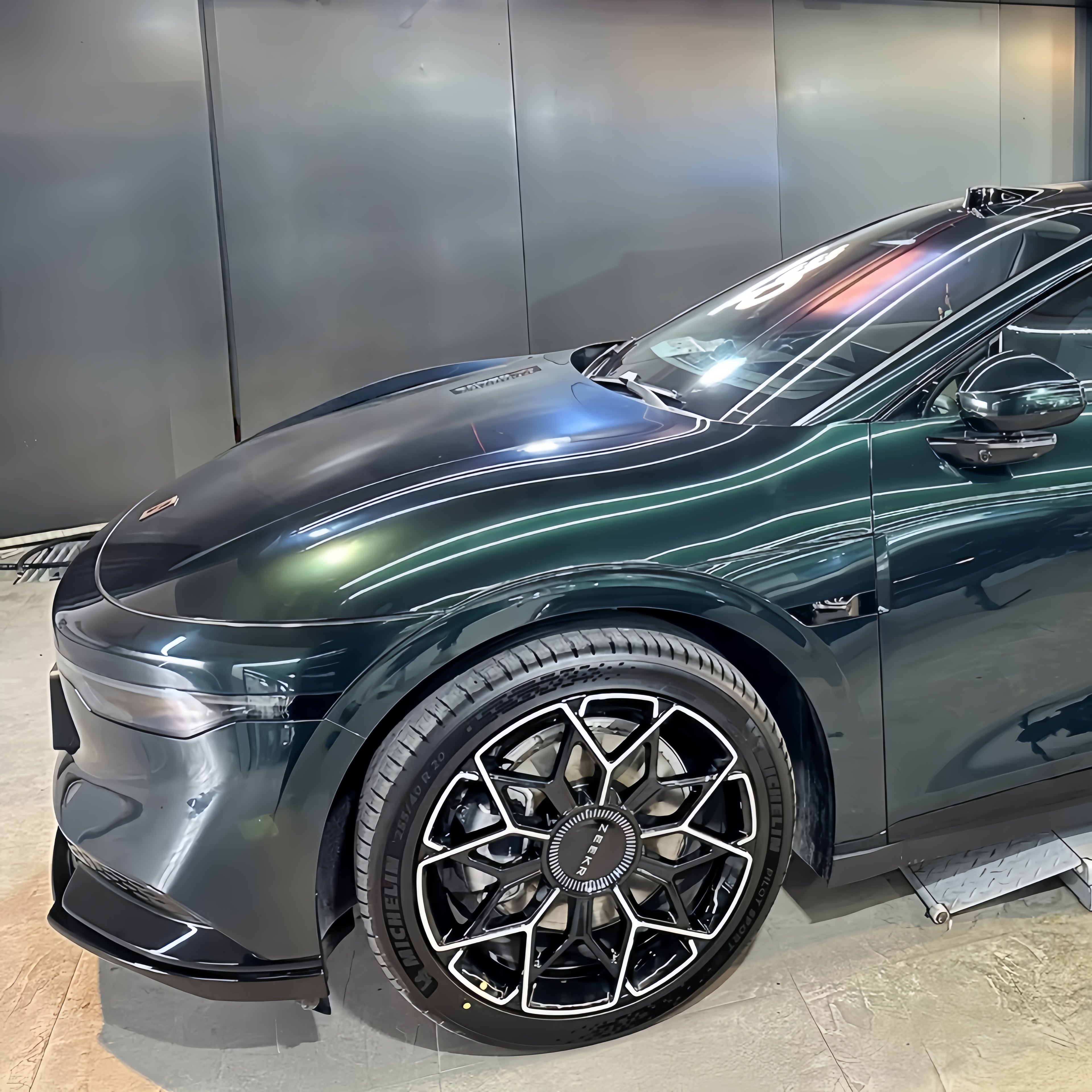 A sports car with Sand Green paint protection film colored wrap is parking in the garage