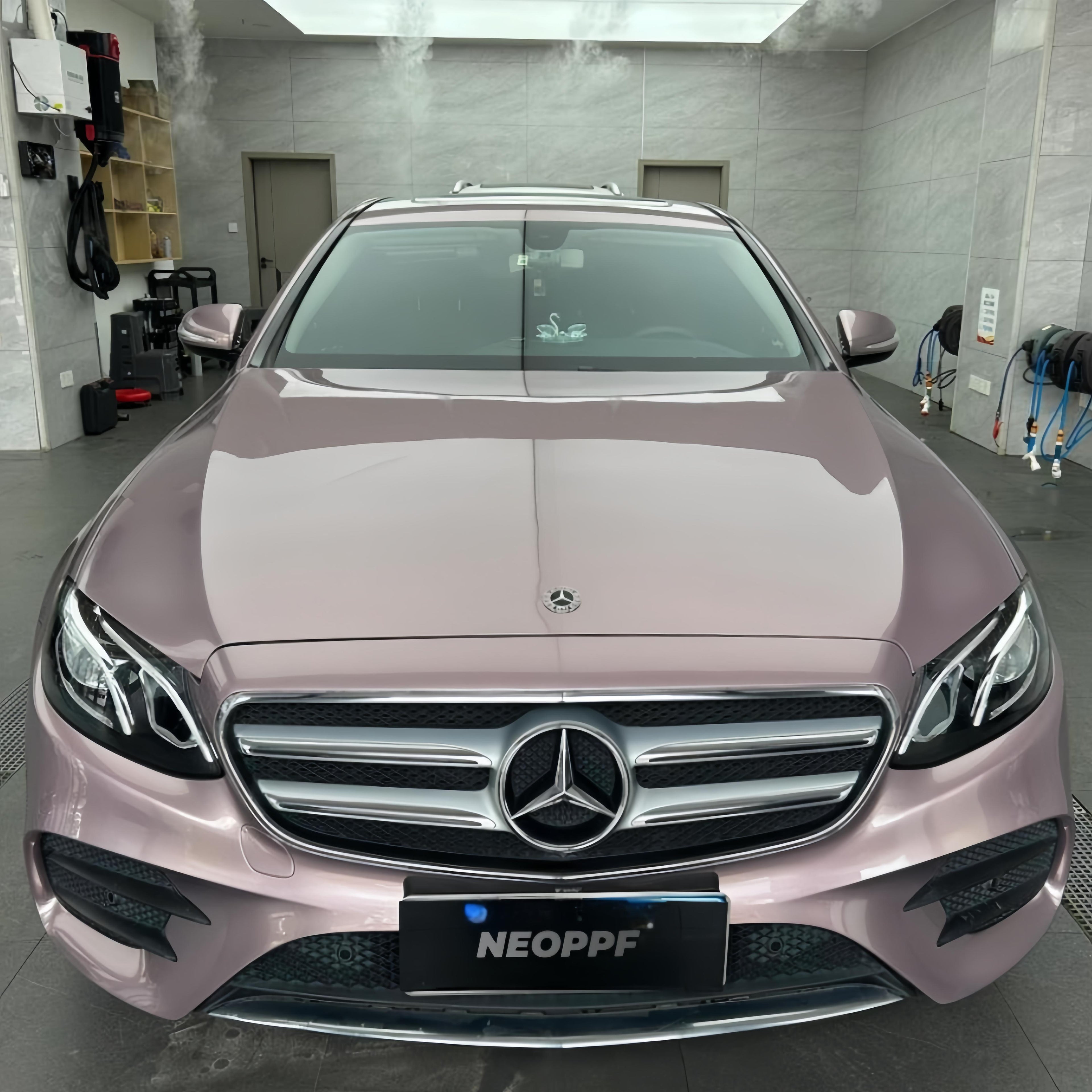 A sports car with Iced Berry Pink paint protection film colored wrap is parking in the garage