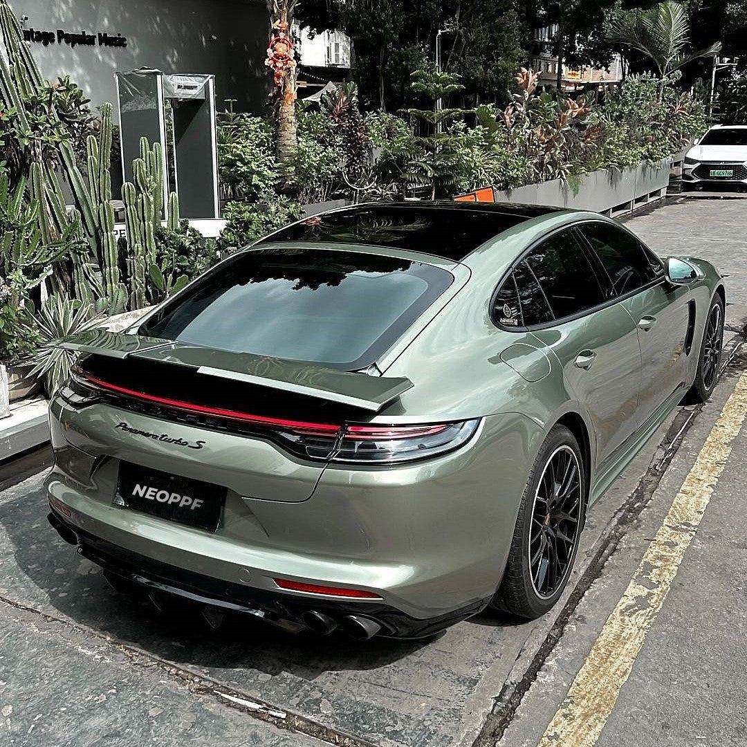 A sports car with Aventurine Green paint protection film colored wrap is parking in the garage