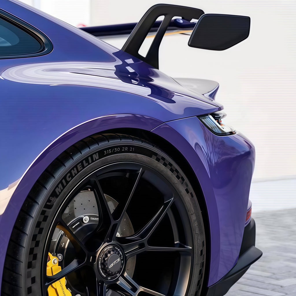 A sports car with GT Violet paint protection film colored wrap is parking in the garage