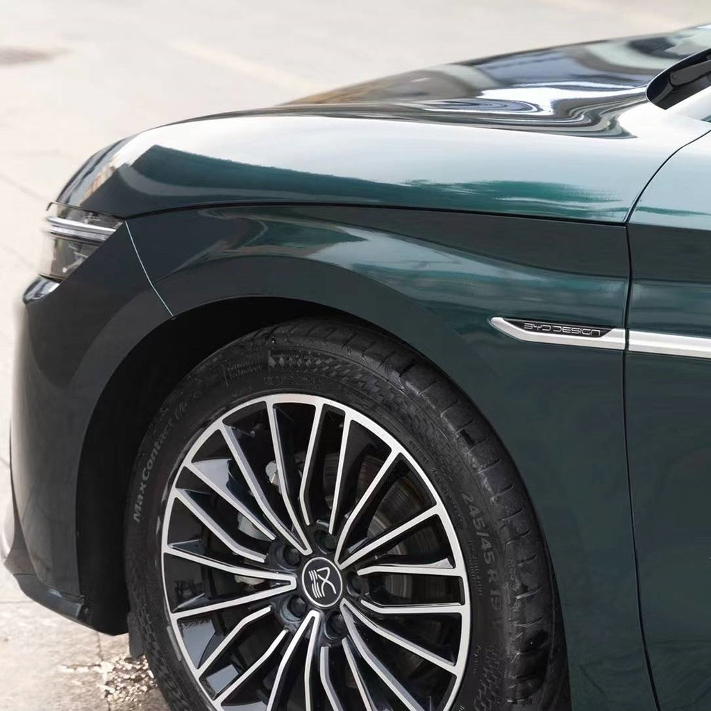 A sports car with Verdant Green paint protection film colored wrap is parking in the garage