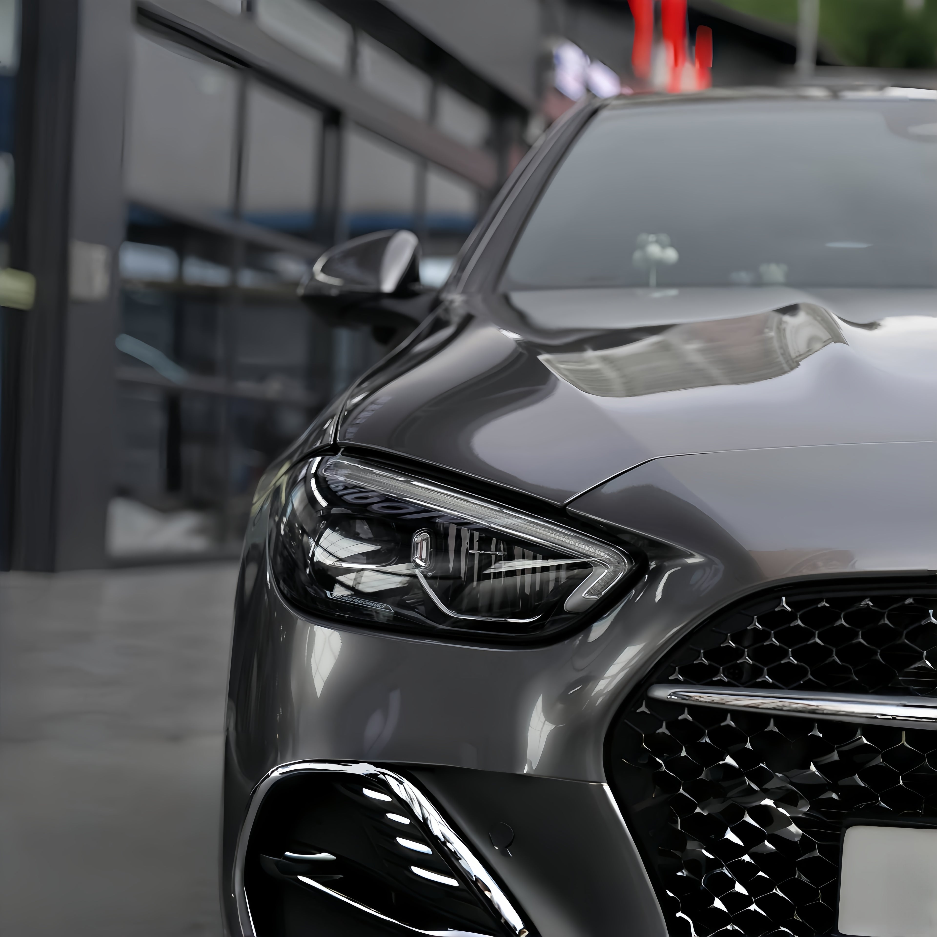 A sports car with Glowing Starlight Silver paint protection film colored wrap is parking in the garage