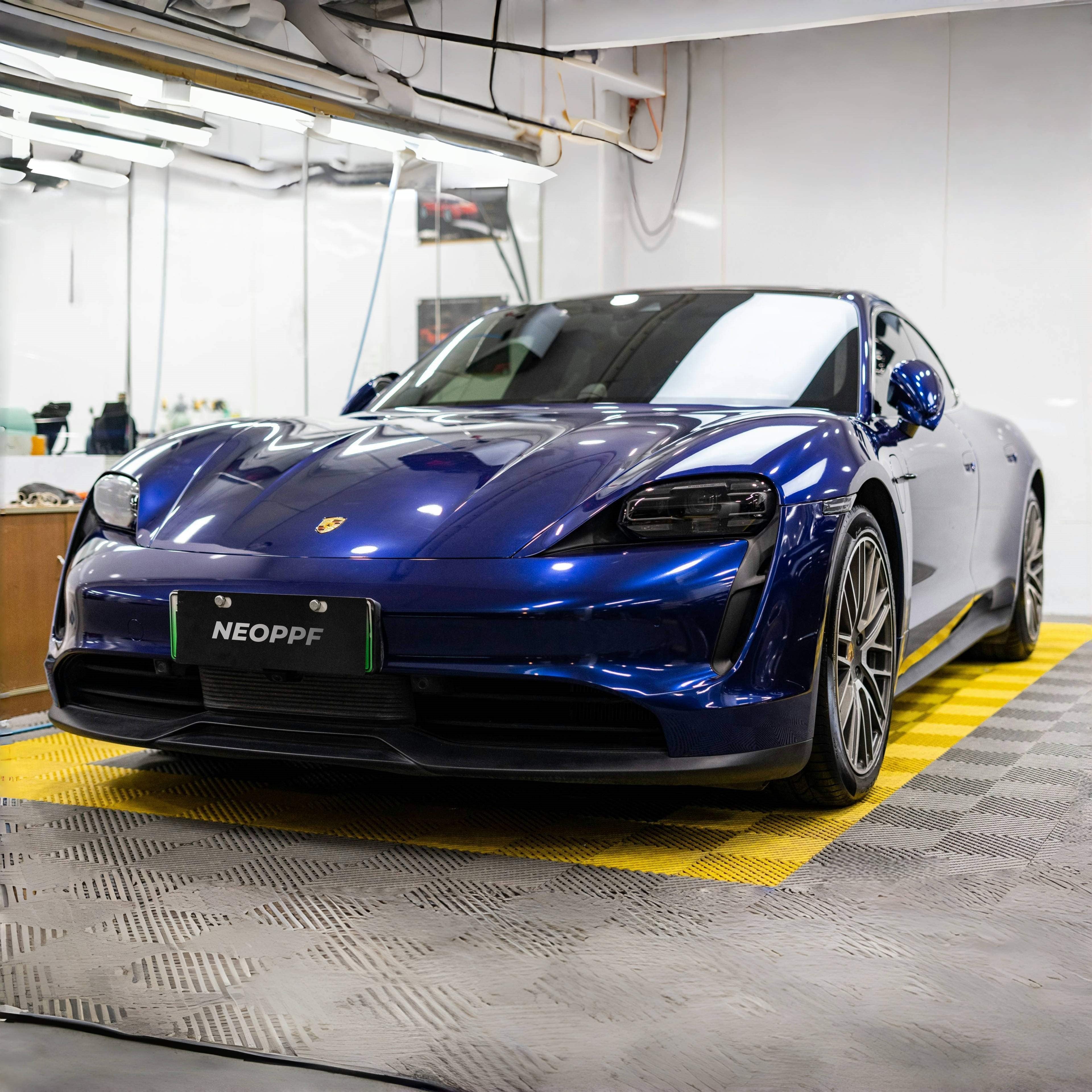 A sports car with Gentian Blue paint protection film colored wrap is parking in the garage