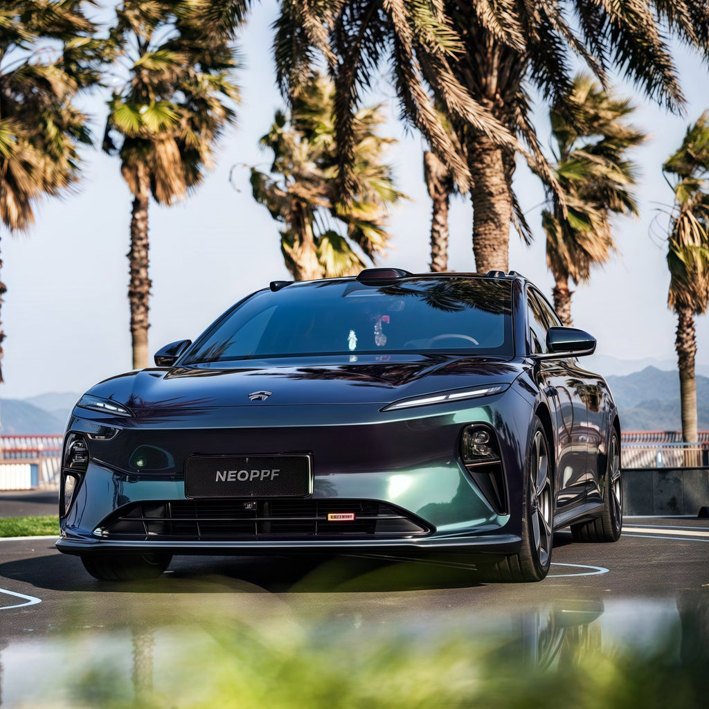 A sports car with Diamond Aurora Green paint protection film colored wrap is parking in the garage