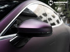 A sports car with Satin Pinot Noir Purple paint protection film colored wrap is parking in the garage