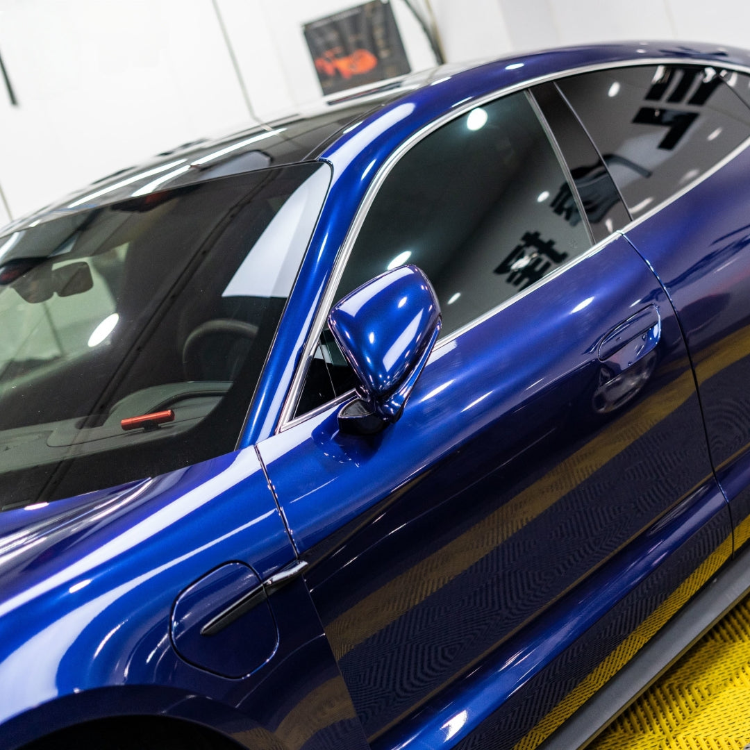 A sports car with Gentian Blue paint protection film colored wrap is parking in the garage