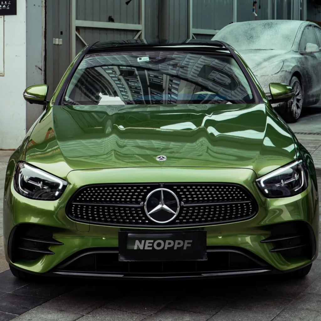 A sports car with Mamba Green paint protection film colored wrap is parking in the garage