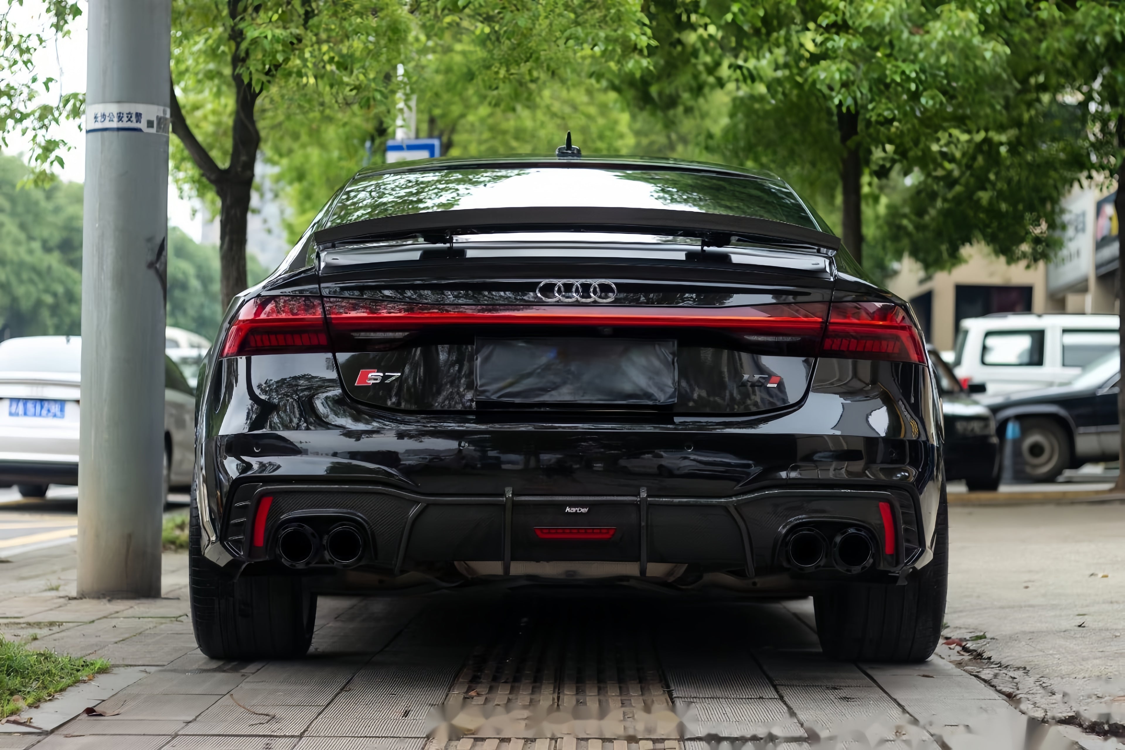 A sports car with Obsidian Black paint protection film colored wrap is parking in the garage