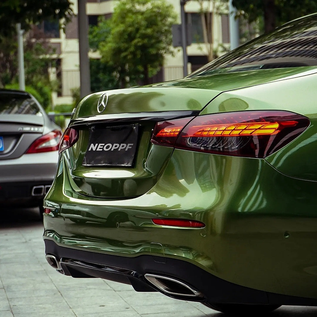 A sports car with Mamba Green paint protection film colored wrap is parking in the garage