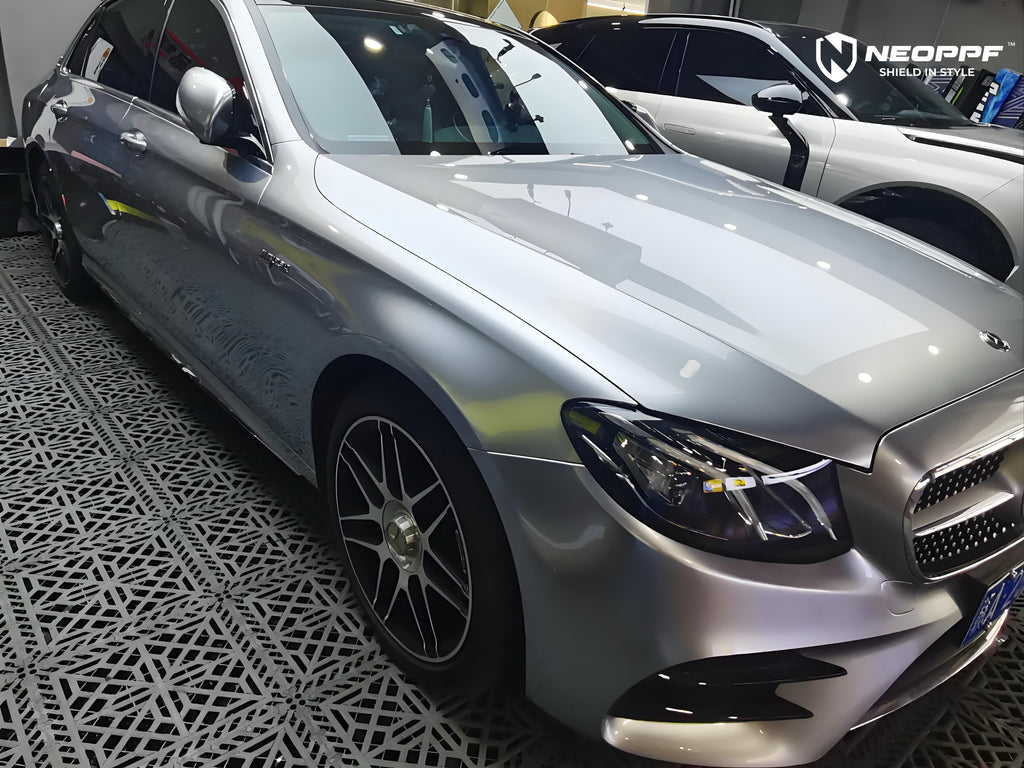 A sports car with Matte Optical Silver Carbon Fiber paint protection film colored wrap is parking in the garage
