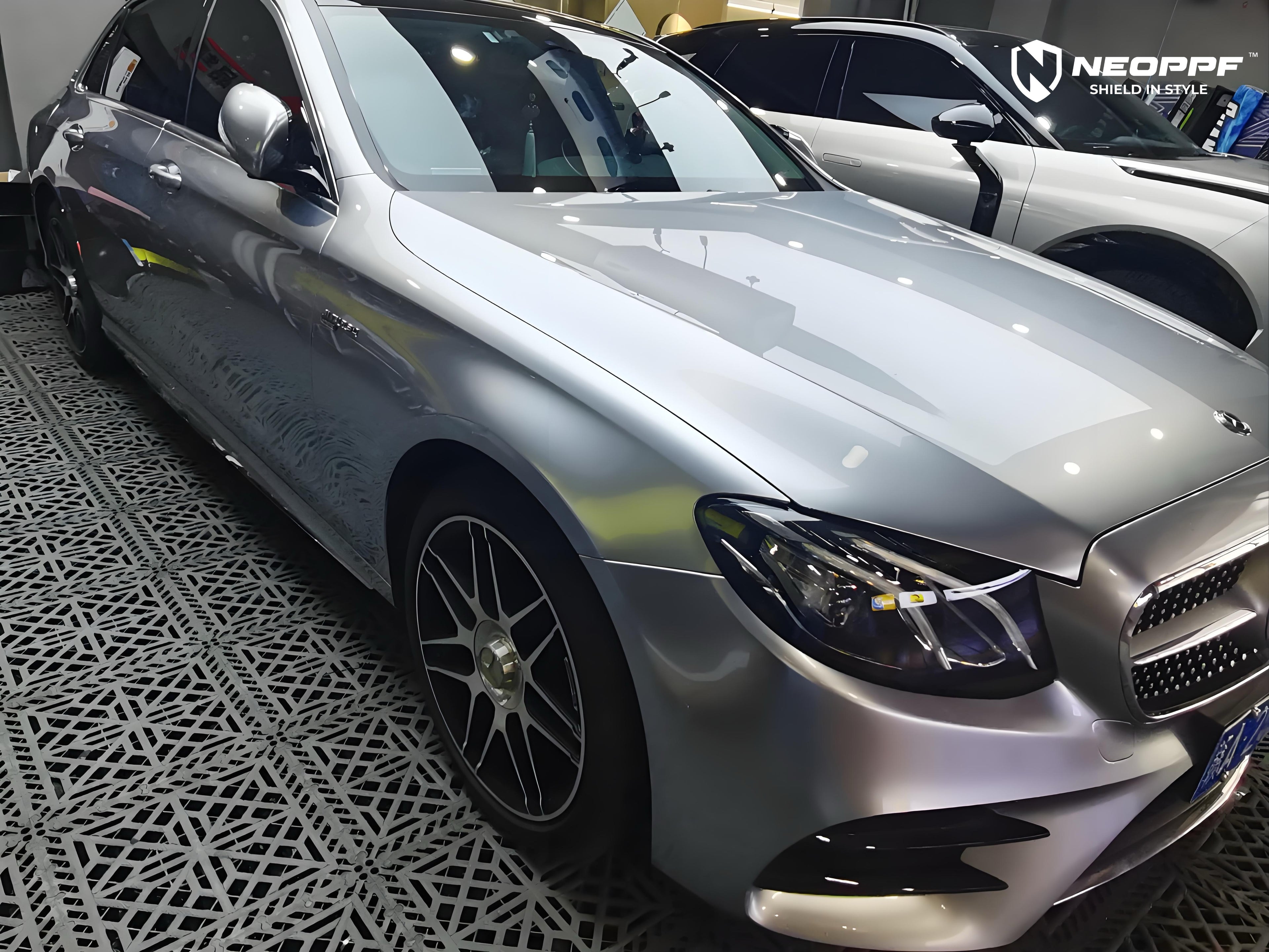 A sports car with Matte Optical Silver Carbon Fiber paint protection film colored wrap is parking in the garage