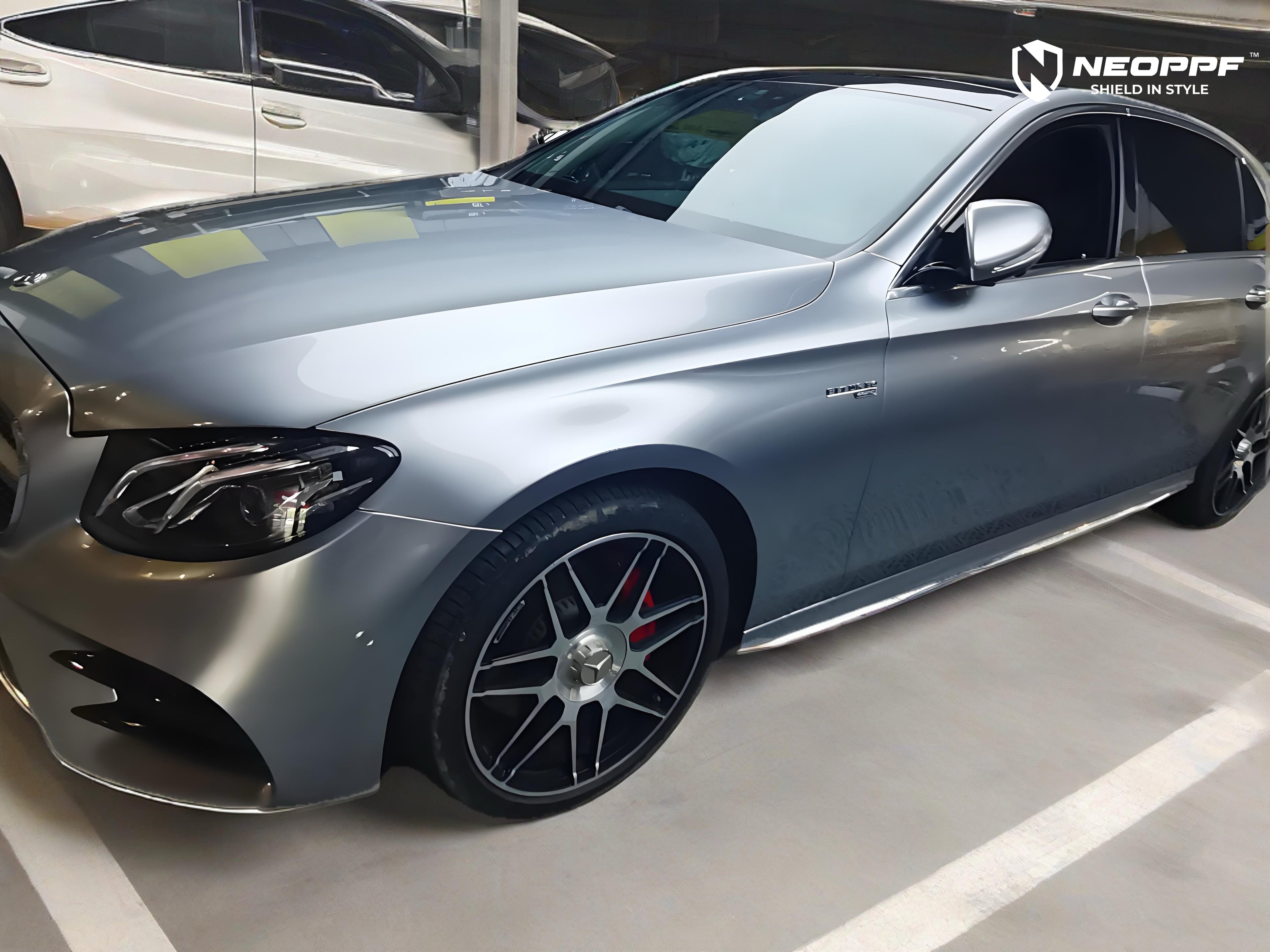 A sports car with Matte Optical Silver Carbon Fiber paint protection film colored wrap is parking in the garage