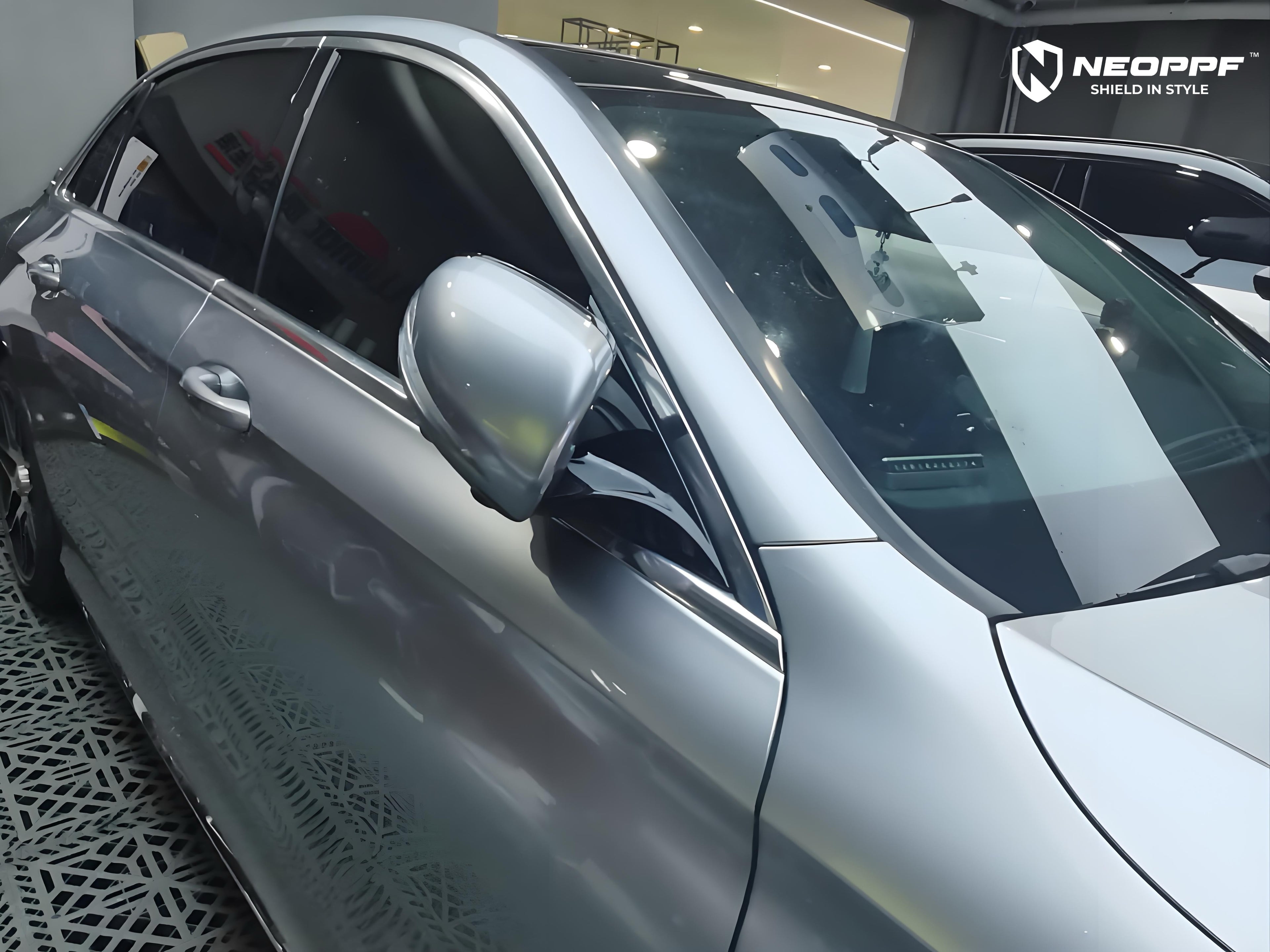 A sports car with Matte Optical Silver Carbon Fiber paint protection film colored wrap is parking in the garage