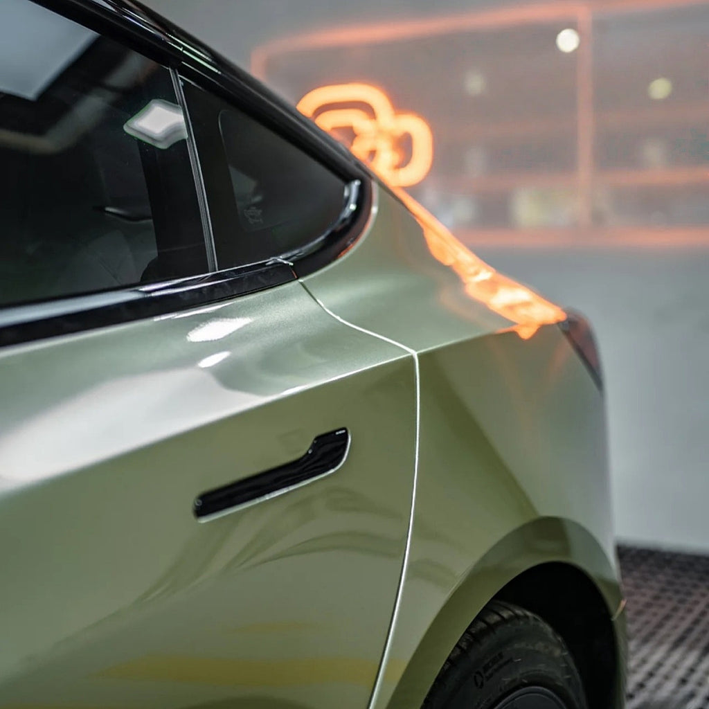 A sports car with Alpine Green paint protection film colored wrap is parking in the garage