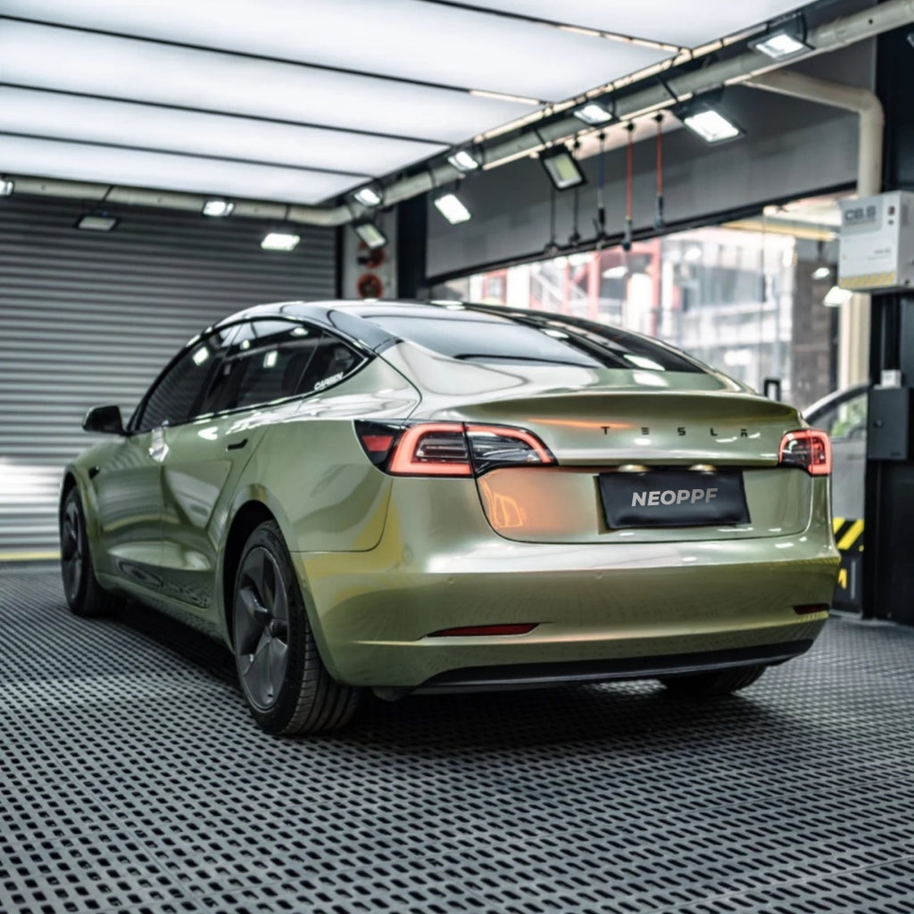 A sports car with Alpine Green paint protection film colored wrap is parking in the garage