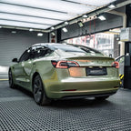 A sports car with Alpine Green paint protection film colored wrap is parking in the garage