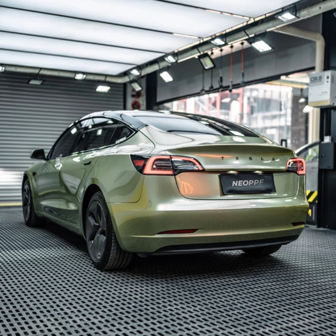 A sports car with Alpine Green paint protection film colored wrap is parking in the garage
