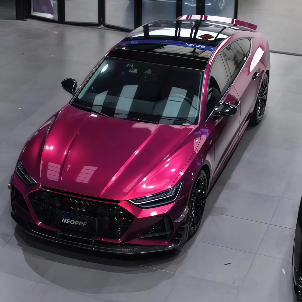 A sports car with Glazed Tata Red paint protection film colored wrap is parking in the garage
