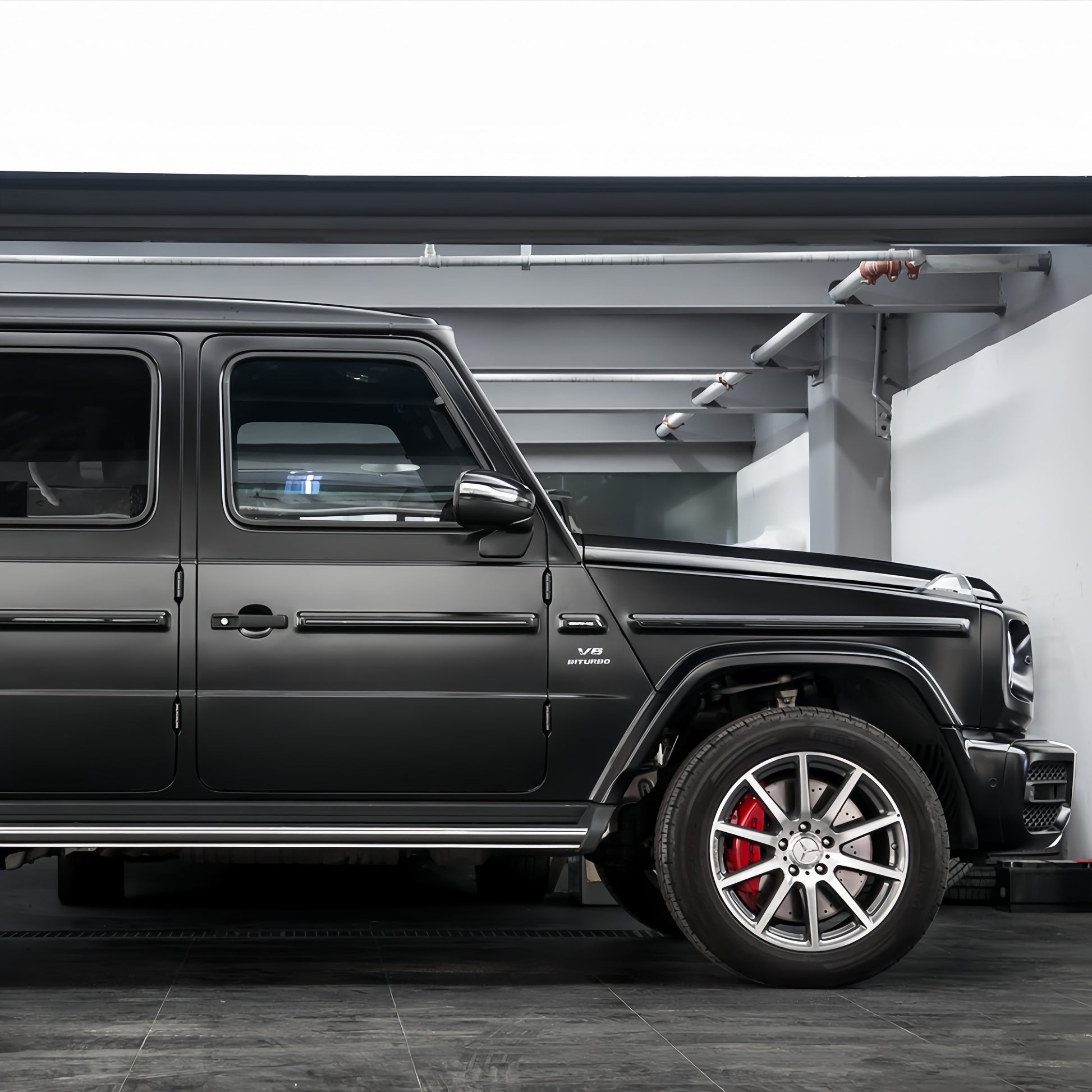 A sports car with Satin Venom Black paint protection film colored wrap is parking in the garage