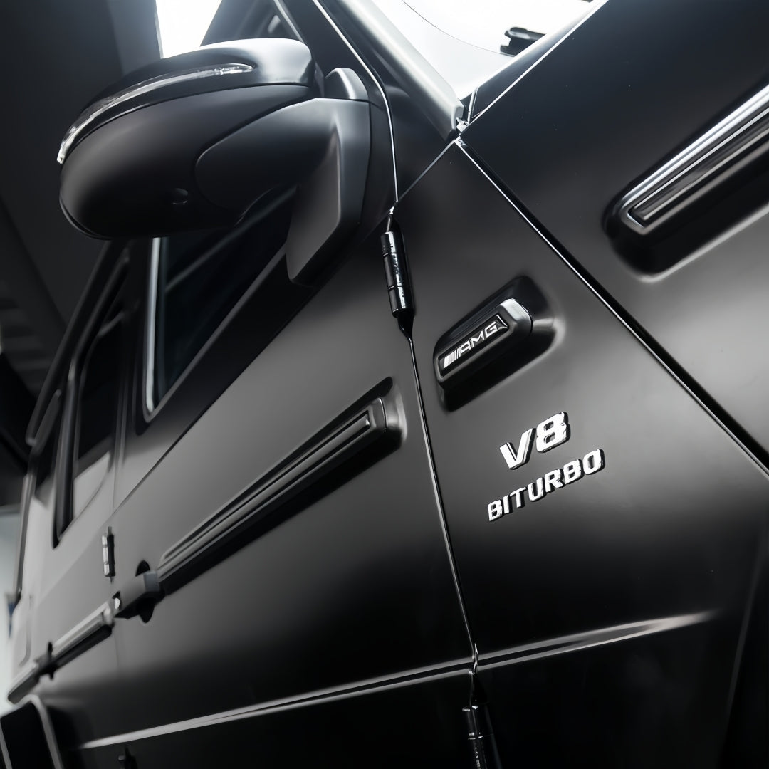 A sports car with Satin Venom Black paint protection film colored wrap is parking in the garage