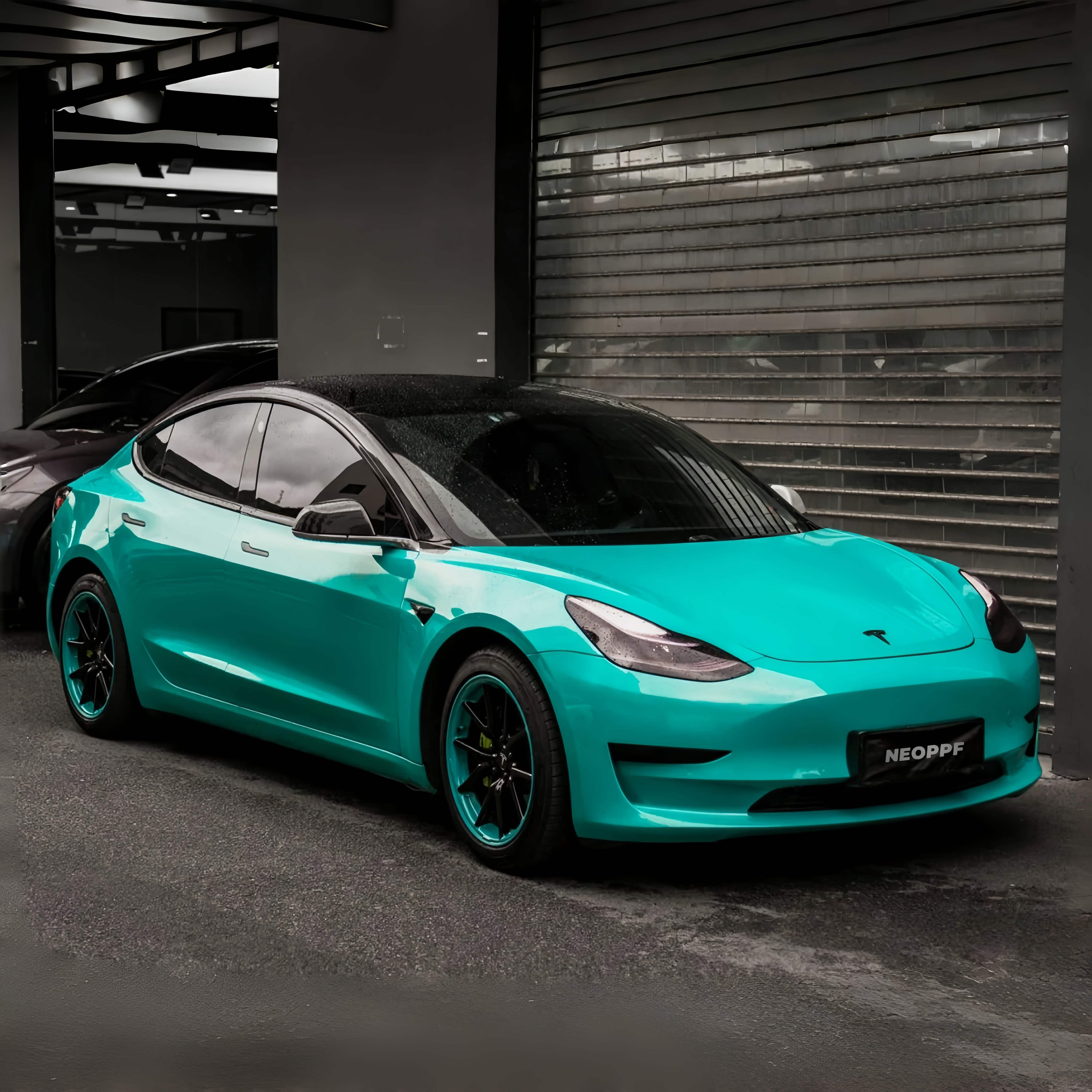 A sports car with Turquoise Blue paint protection film colored wrap is parking in the garage